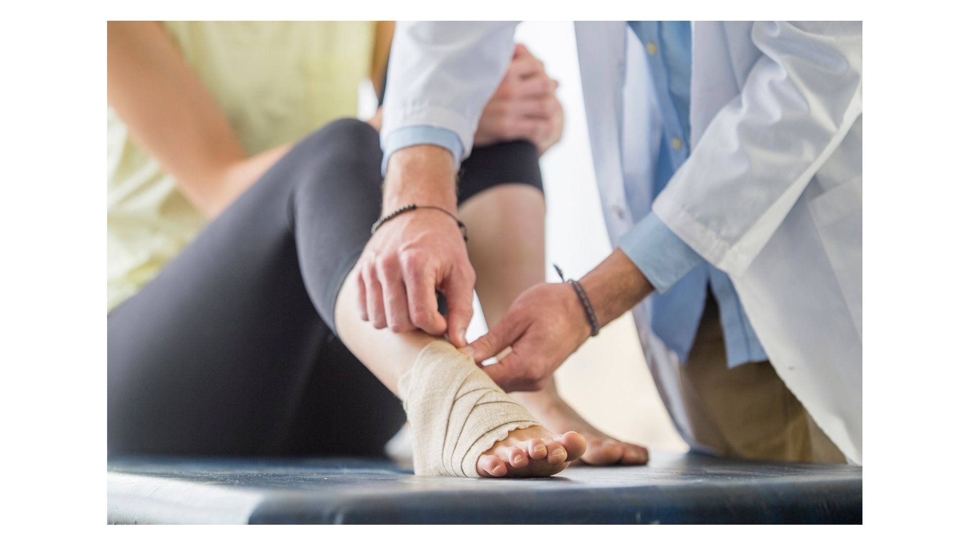 Chiropractor wrapping a patient's ankle injury during personal injury recovery at Birch Chiropractic & Rehab in North Kansas City