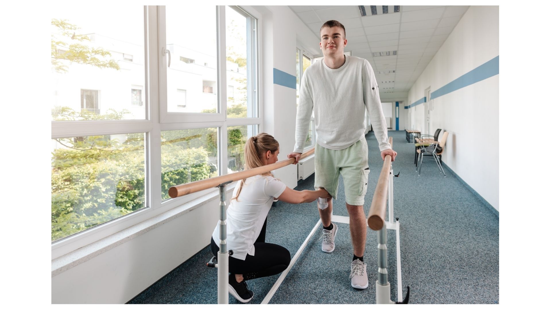 Therapist guiding an athlete through parallel bar walking during sports rehabilitation at Birch Chiropractic & Rehab in North Kansas City Therapist guiding an athlete through parallel bar walking during sports rehabilitation at Birch Chiropractic & Rehab in North Kansas City